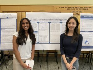 Two students standing in front of their research poster