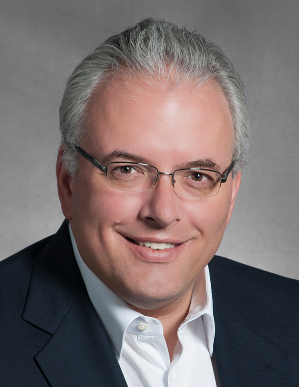A headshot of Dieter Moeller against a gray background