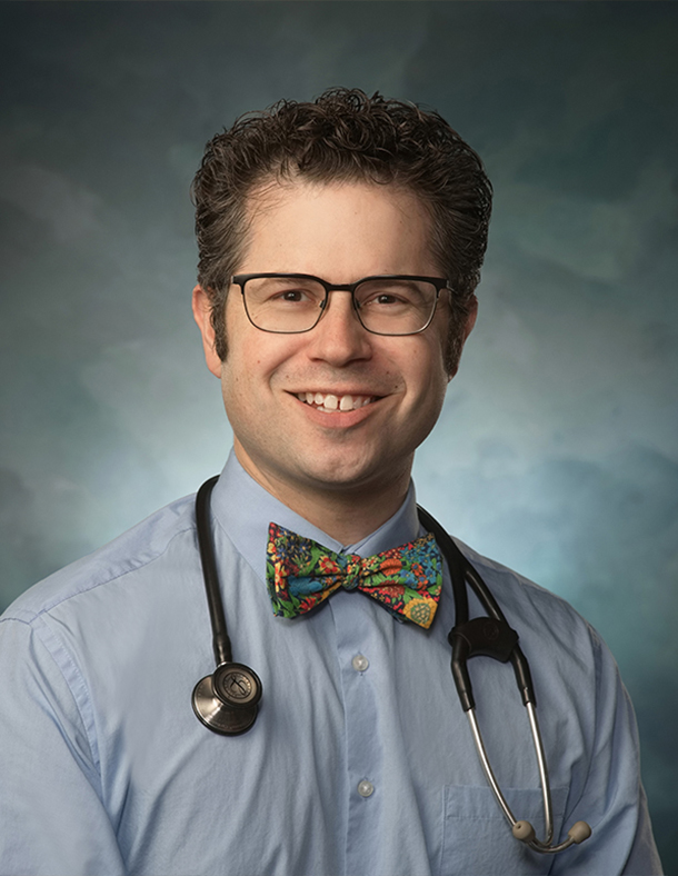 A headshot of Zachary Rubin with a stethoscope around his neck