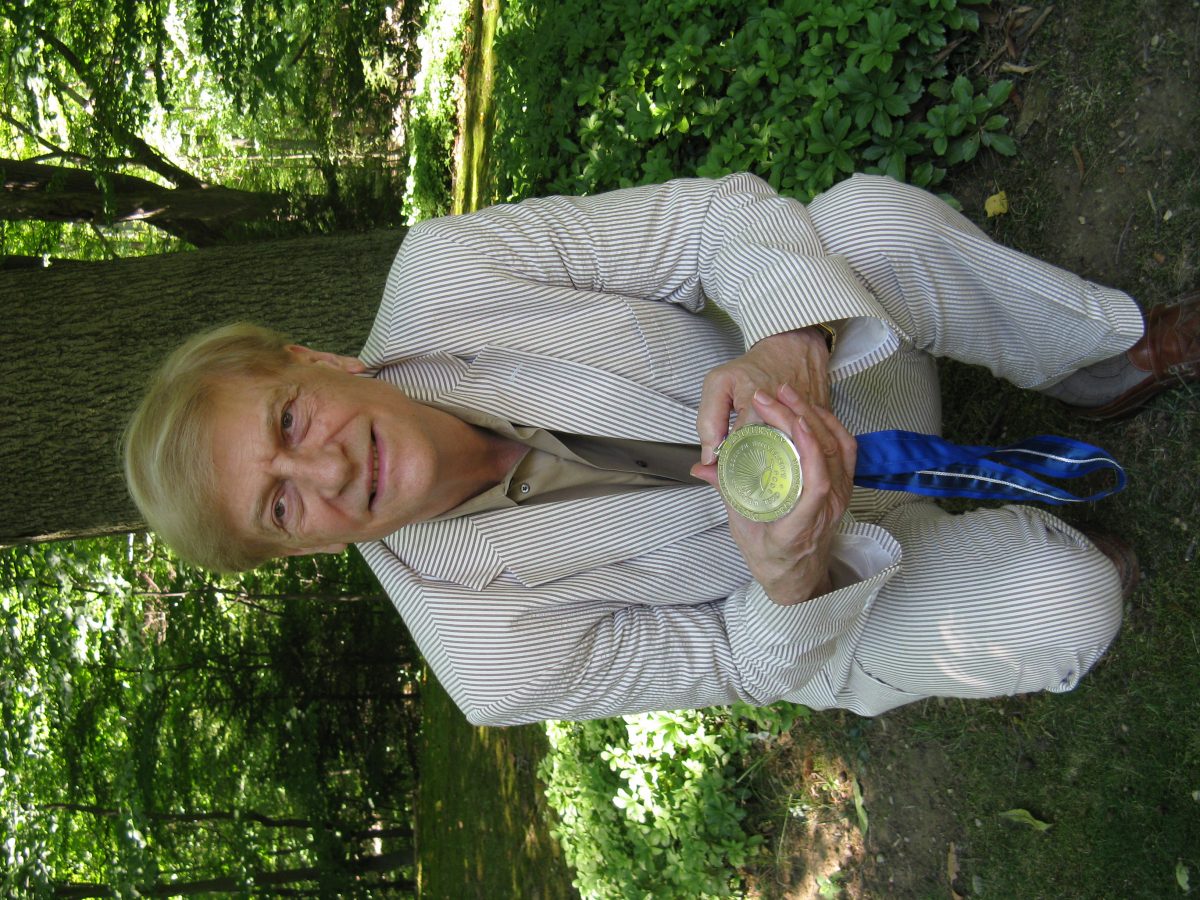 Prof. Robert "Doc" Brown, shown here in characteristic un-pretentious fashion, with his Distinguished University Professor award.