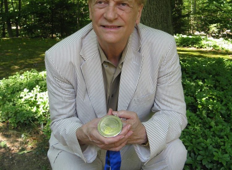 Prof. Robert "Doc" Brown, shown here in characteristic un-pretentious fashion, with his Distinguished University Professor award.