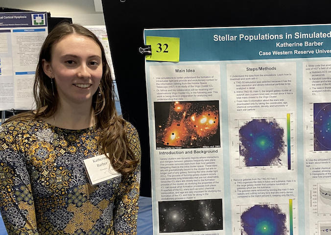 undergraduate woman with nametag by academic poster with data, images of space