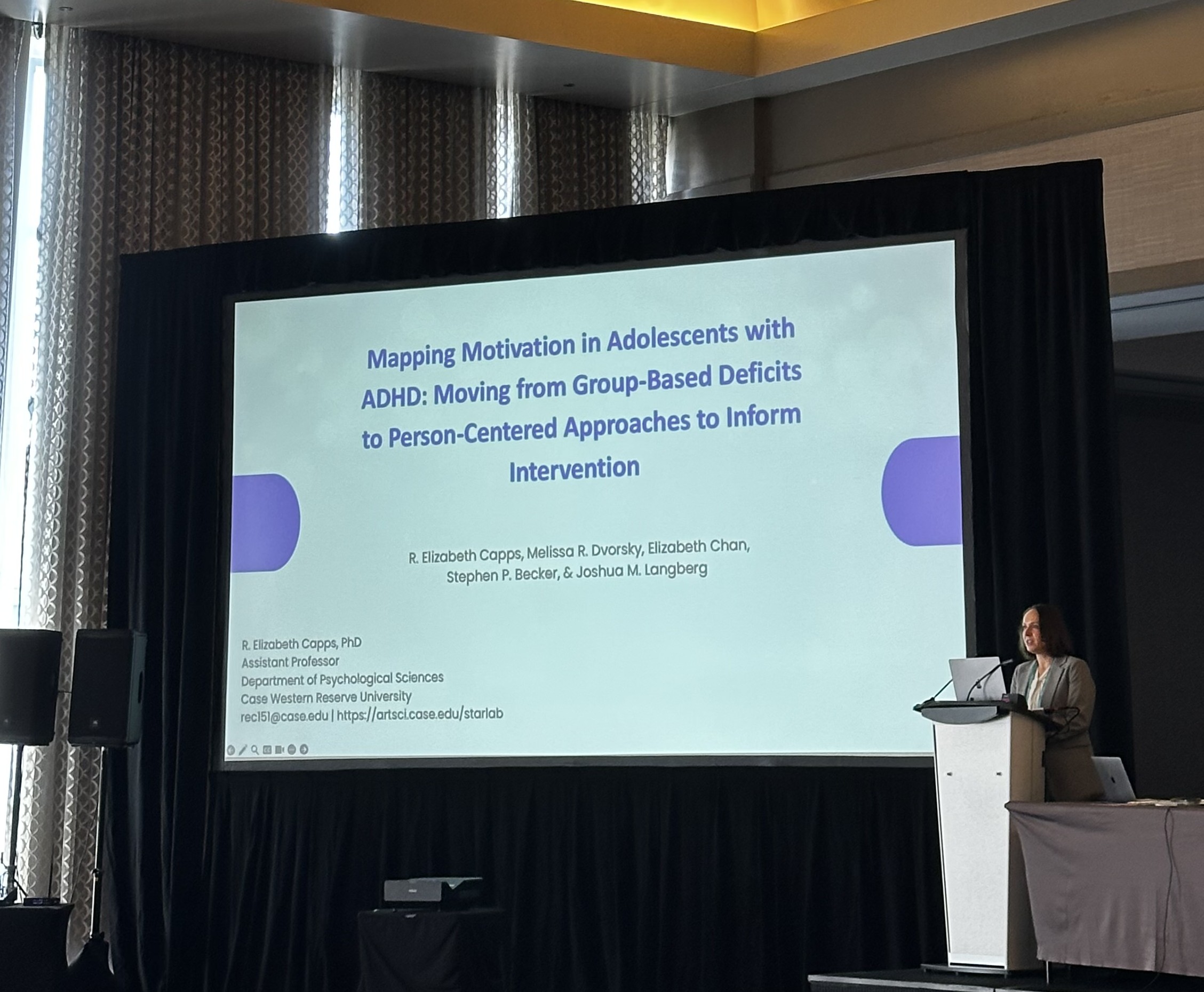 Woman presenting a PowerPoint at a conference meeting