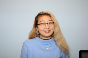 student with long blonde hair and glasses