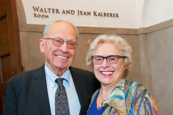 Walter and Jean Kelberer pose for a picture in front of the black box theatre sign which they provided support and is named after them